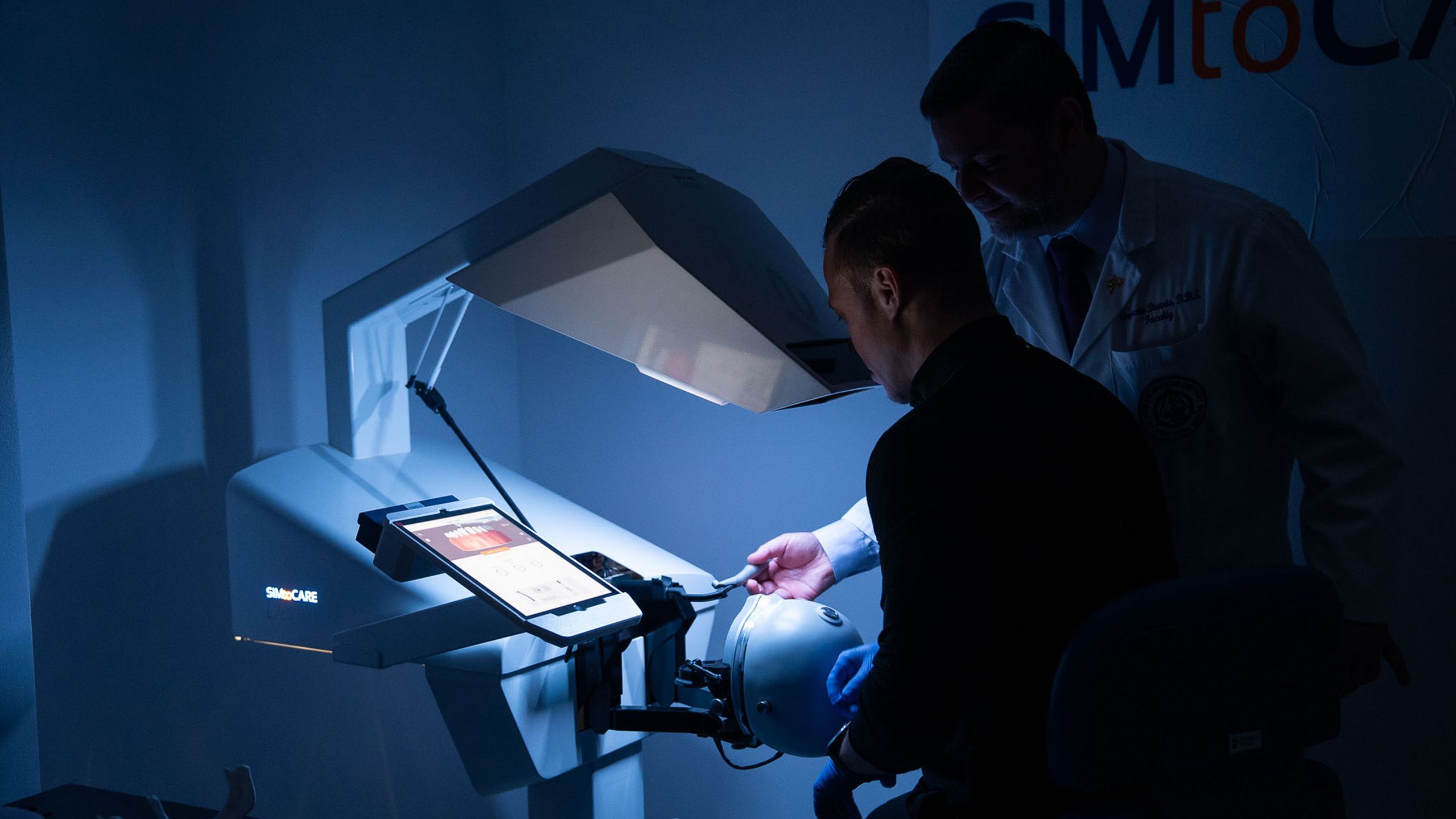 two men in lab looking at tablet screen