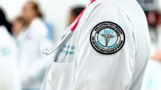 close up of NSU Nursing patch on side of lab coat