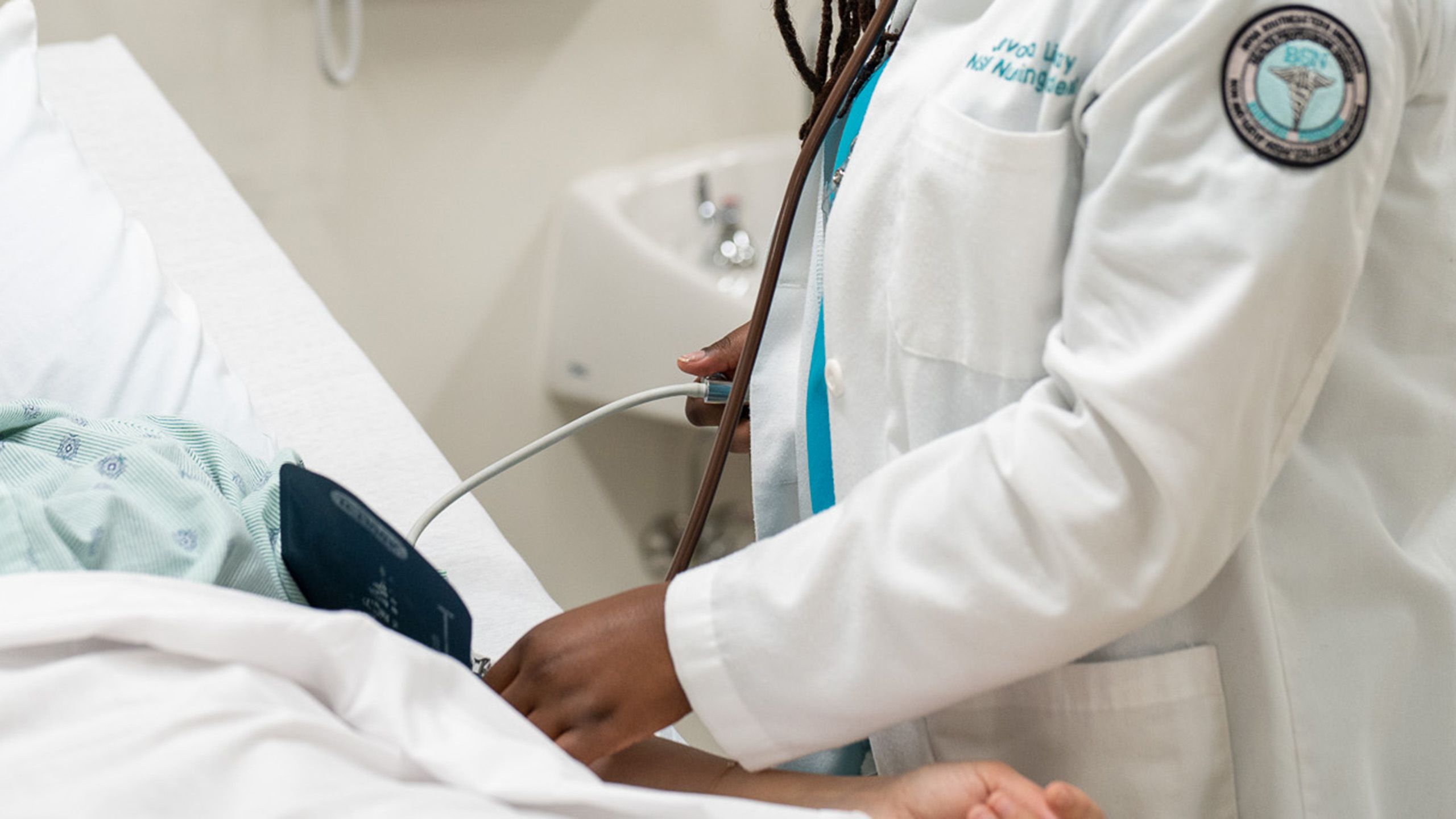 close up of nurse's hand checking a patient's blood pressure